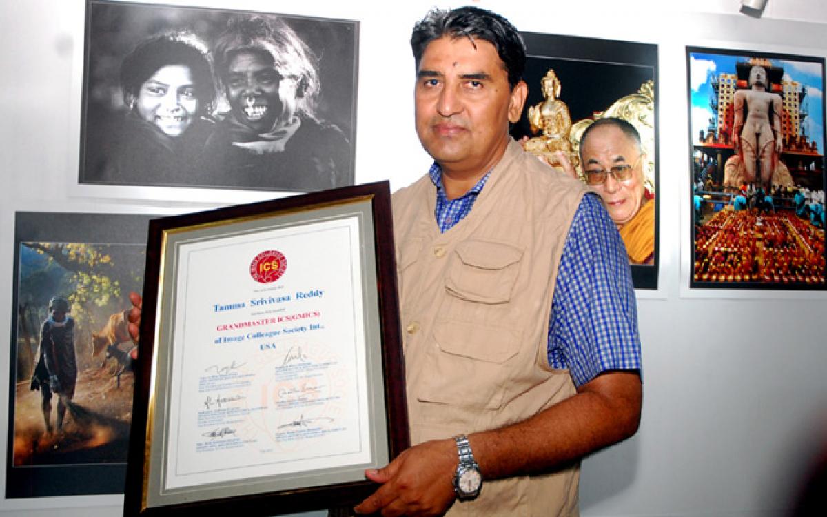 Freelance photographer Tamma Srinivasa Reddy displays the certificate received by him from the ‘Image Colleague Society International’ (ICS), in Vijayawada, on Friday Photo: N Kishore